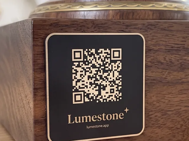 Close-up of an engraved Lumestone plaque on a walnut urn
